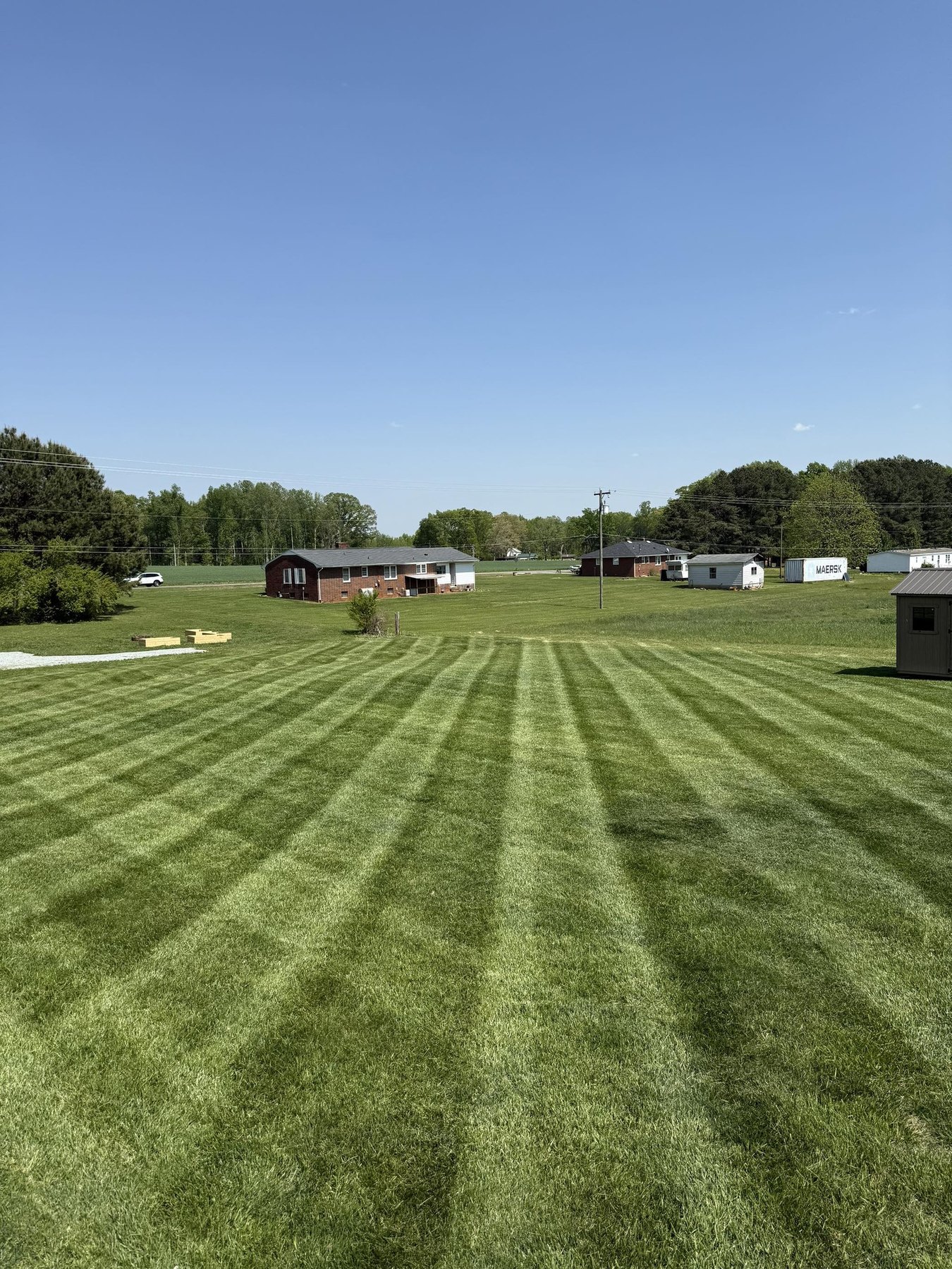 Striped lawn maintained by OJ LANDSCAPE