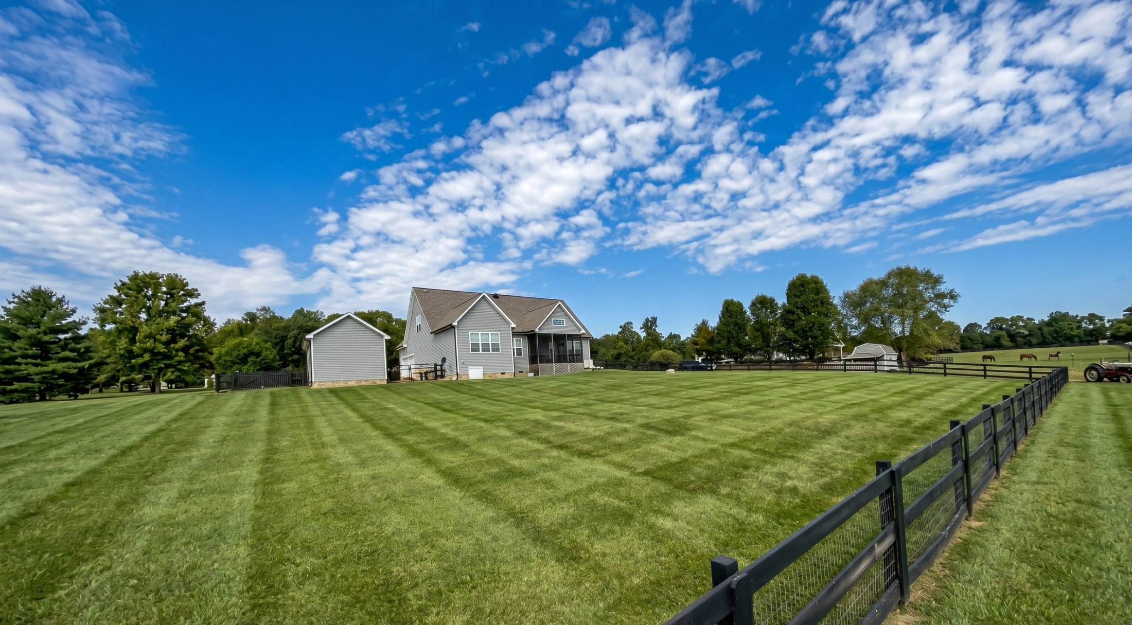 Large striped lawn maintained by OJ LANDSCAPE